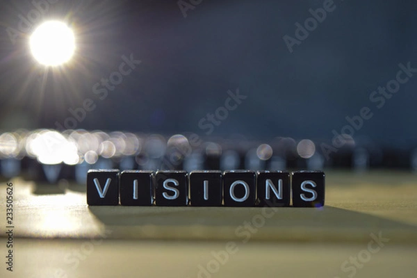 Fototapeta VISIONS concept wooden blocks on the table. With personal development and motivation concept on blurred or black background