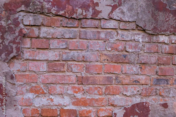 Fototapeta A fragment of a red brick wall at an idle factory,shot in late autumn