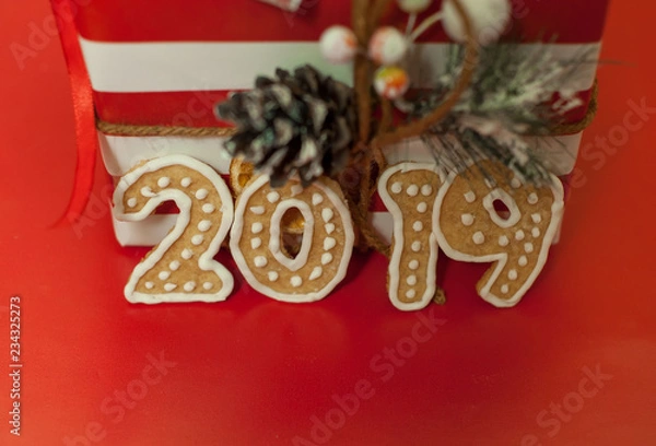 Fototapeta Christmas gifts on a red background with a red ribbon, with numbers 2019