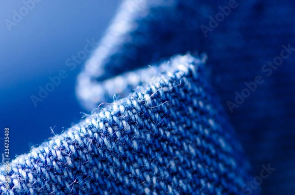 Fototapeta Blue jeans material fabric texture fashion seam fittings macro blur background