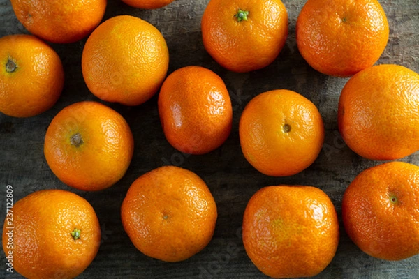 Obraz A lot of tangerines on a wooden background.