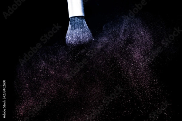 Fototapeta purple and pink powder color splash and brush for makeup artist or beauty blogger in black background, look like a galaxy and mystic mood.