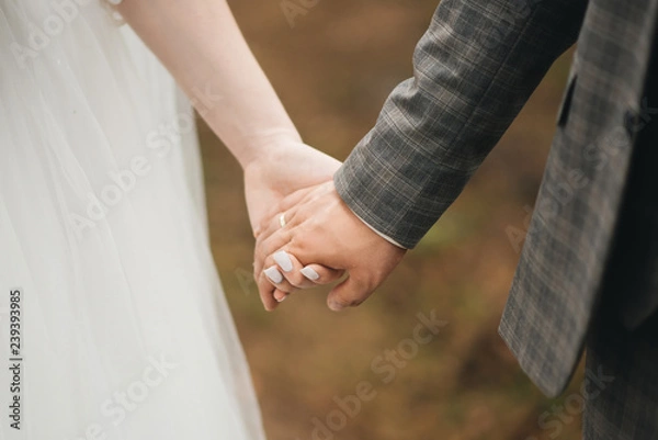 Fototapeta wedding photo. Hands of bride and groom