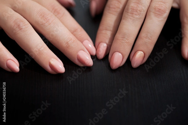 Fototapeta Nude manicure with gold decor. Womens hands close up