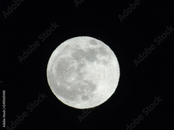 Fototapeta An amazing photography of the full  moon over the city of Genova by night with a great clear sky in background and some stars