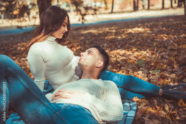 Fototapeta Divine couple lying in autumn park