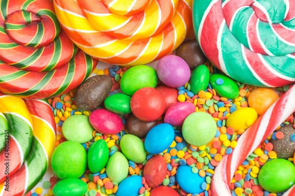 Fototapeta Colorful lollipops and different colored candy closeup