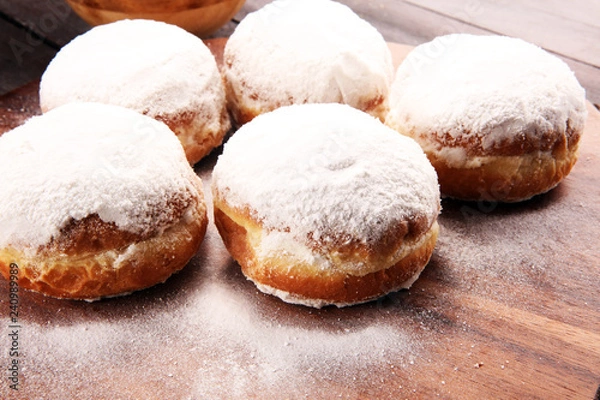 Fototapeta German donuts with jam and icing sugar. Carnival powdered sugar raised donuts