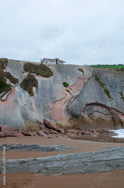 Fototapeta ZUMAIA, BASQUE COUNTRY, SPAIN - 2018 - Hermitage of San Telmo, famous for appearing in the highest grossing film of Spain "8 Basque surnames", on the flysh of the beach.