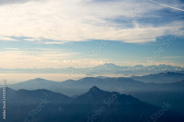 Fototapeta Panoramic view of the Italian Alps with fog on the Padana plain, Monte Rosa in the background. Viewpoint from the summit of Monte Resegone, Lombardy. Italian Landscape.