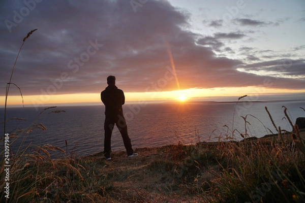 Fototapeta Man looking into the Sunset - Ireland