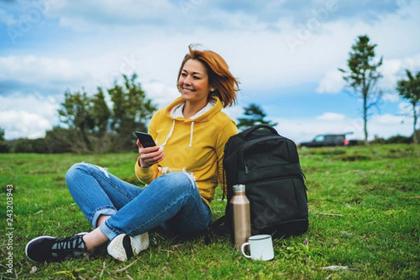 Fototapeta smile woman holding in female hands gadget technology, tourist young girl text message on background green grass using mobile smartphone, hiker enjoy recreation, online wifi internet lifestyle concept