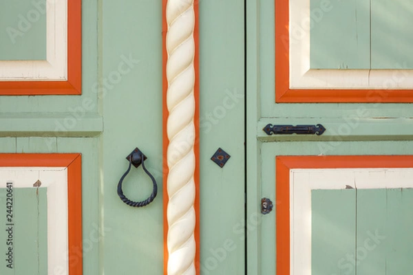 Fototapeta Beautiful wooden door with a round metal handle. door knocker with a ring. background texture