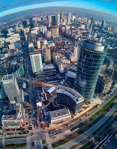 Fototapeta WARSAW, POLAND - NOVEMBER 27, 2018: Beautiful panoramic aerial drone view to the center of Warsaw City and The Warsaw Spire - 220 metre neomodern office building on European square (Plac Europejski)