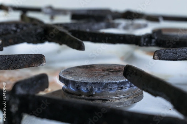 Fototapeta Gas burner on an old stove with fire