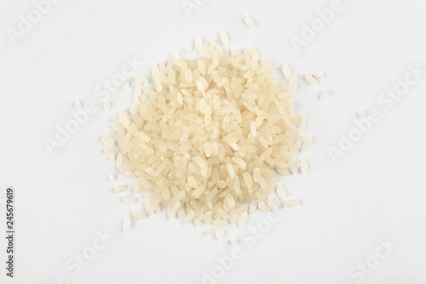 Fototapeta Pile of white rice on a white background