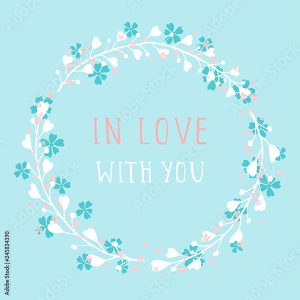 Fototapeta Vector hand drawn illustration of text IN LOVE WITH YOU and floral round frame on blue background. Colorful.