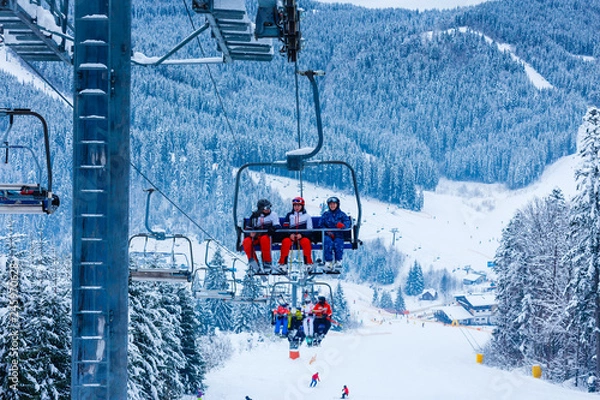 Fototapeta Skiing, ski lift - skiers on ski vacation