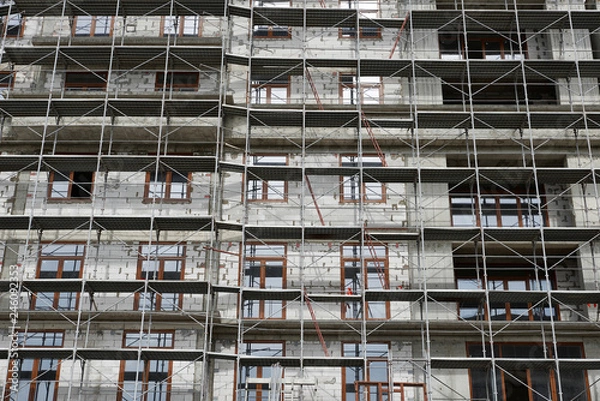 Fototapeta new building under construction, scaffolding and concrete