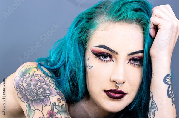 Fototapeta Attracive woman with tattoos and blue hair