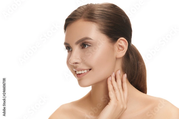 Fototapeta The beautiful happy smiling female face. The perfect and clean skin of face on white. The beauty, care, skin, treatment, health, spa, cosmetic concept