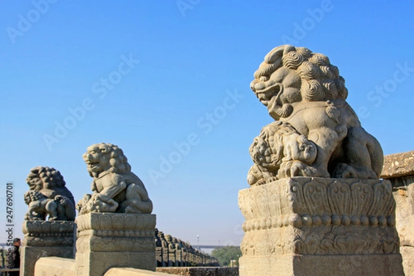 Fototapeta stone lion on bridge railing, China