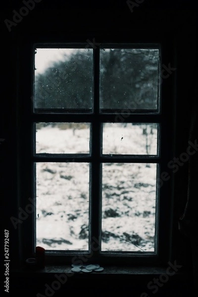 Fototapeta Worn window with a winter view. Old window in europe