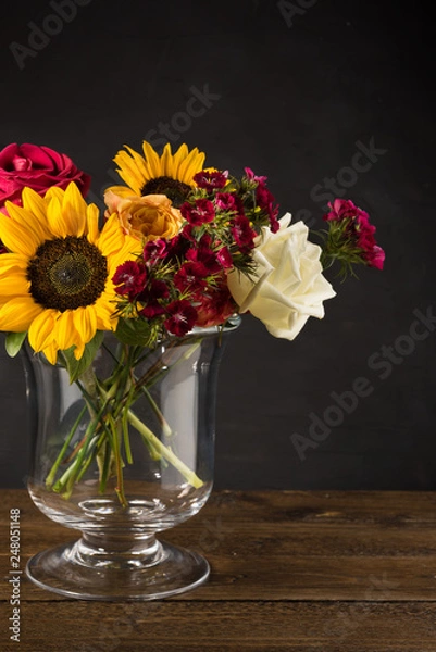 Fototapeta Bouquet of white yellow and red flowers in a vase on a dark background