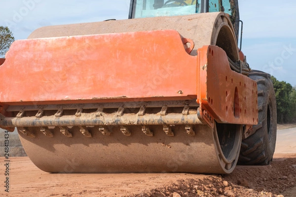 Fototapeta Soil or Tandem or Road vibratory compactor working on road work construction site.