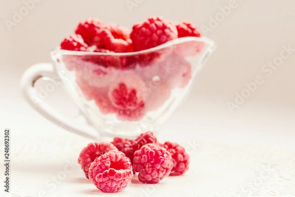 Fototapeta Bowl of raspberry on the white background. Horizontal image, copy space, close-up, macro