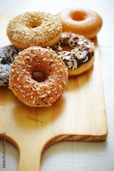 Fototapeta Donuts on wooden board 