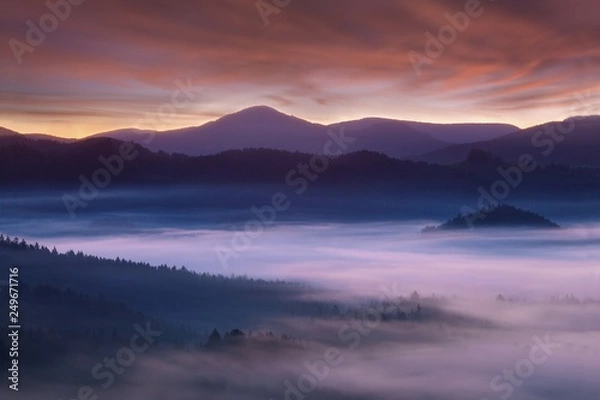 Obraz Beautiful summer or autumn sunrise above the forest valley of National park Bohemian Switzerland. Warm sunrise above the deep misty valley. Wonderful landscape background concept. Rays of lights 