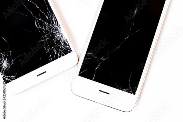 Fototapeta Broken smartphones. White phones on the white background. Crushed screen