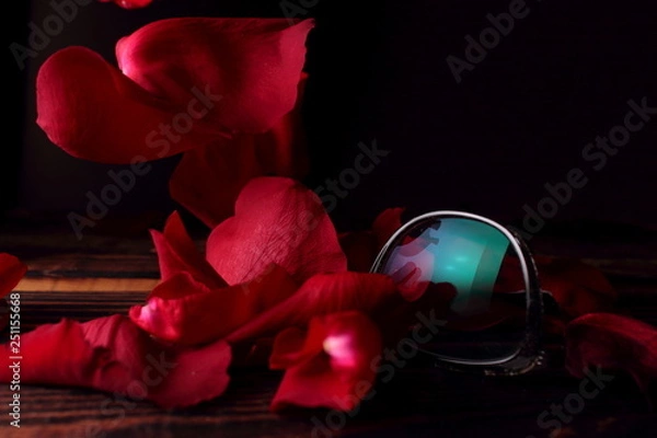 Obraz Red rose petals fall on the table and glasses