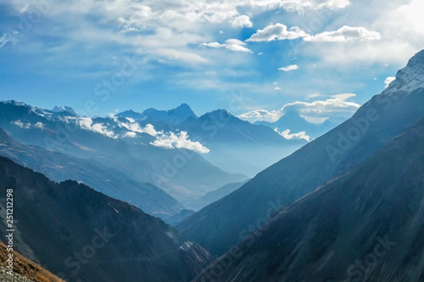 Fototapeta Harsh slopes of Manang Valley, Annapurna Circus Trek, Himalayas, Nepal, with the view on Annapurna Chain and Gangapurna. Dry and desolated landscape.  High mountain peaks, covered with snow.