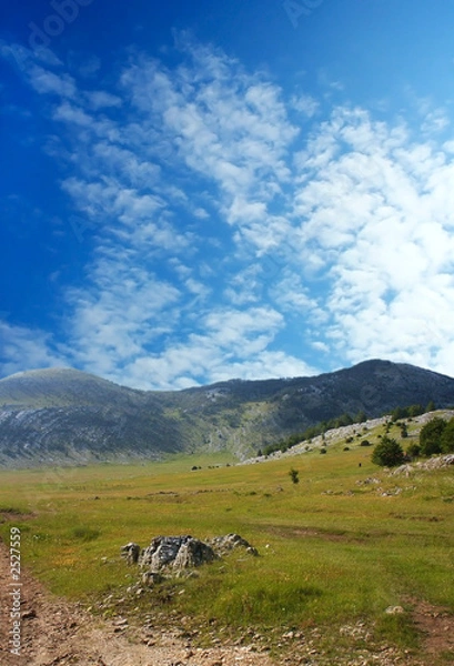 Fototapeta dinara mountain over blue clouds 1