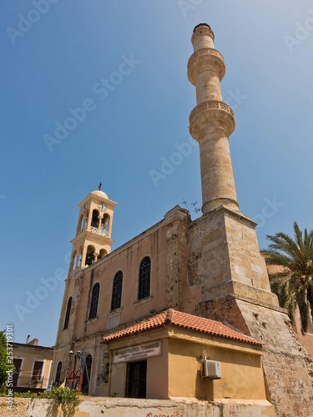 Fototapeta Orthodox church and muslim mosque side by side at the old venetian harbor, city of Chania, Crete island, Greece