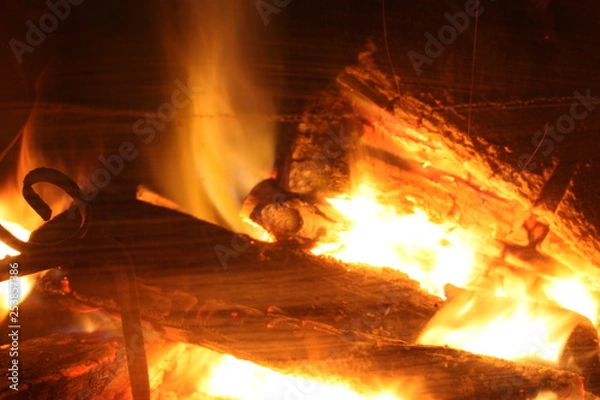 Fototapeta the crackling fire of a lit fireplace that recalls the winter Christmas atmosphere