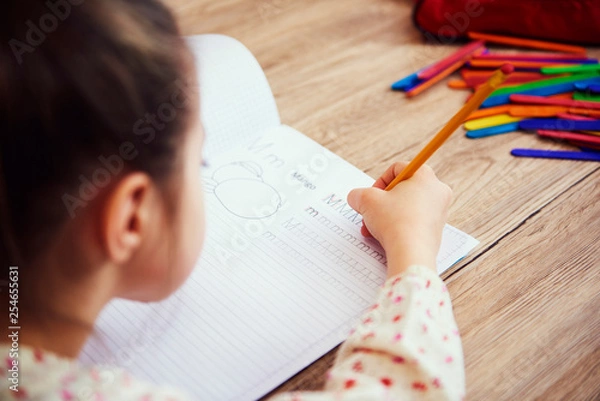 Fototapeta Close up of child doing homework