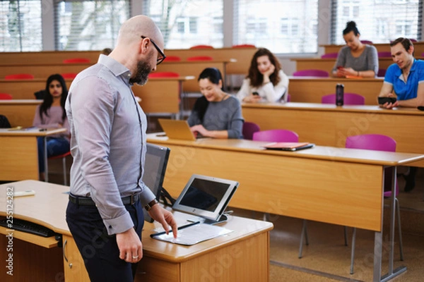 Fototapeta Lecturer and multinational group of students in an auditorium