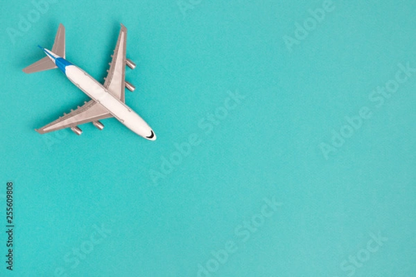 Fototapeta Flat lay airplane on blue background. Concept travel.