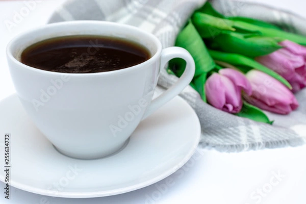 Fototapeta Bouquet of spring flowers, pink tulips on checkered plaid background with a cup of coffee - holiday business card for 8 march, Valentine day or mother's day