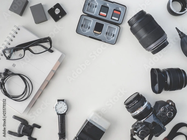 Fototapeta top view of work space photographer with digital camera, flash, cleaning kit, white table background.