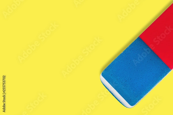 Fototapeta Single rectangular rubber eraser for pencil and pen ink on yellow background with copy space for your text