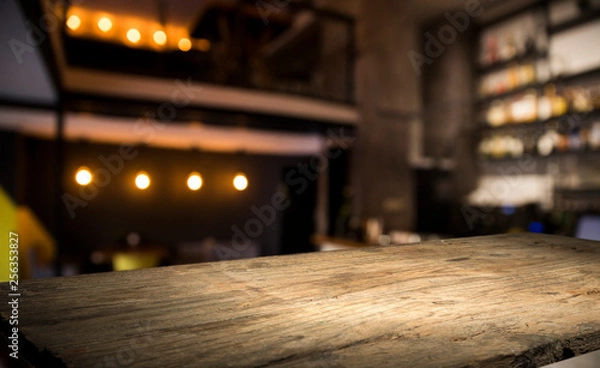 Fototapeta blurred background of bar and dark brown desk space of retro wood