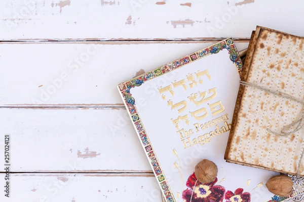 Fototapeta Pack of matzah or matza on a vintage wood background with copy space or text space. Top view or above view composition.