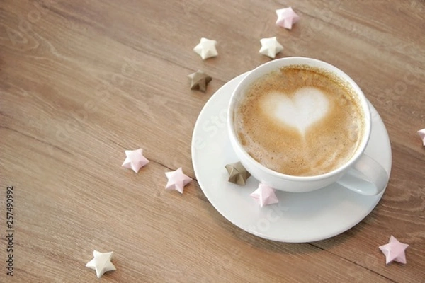 Fototapeta cup of cappuccino with heart-shaped foam.