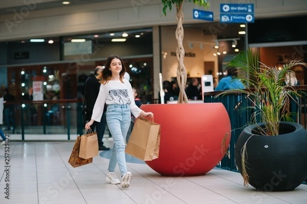 Fototapeta Shopping time, teenage girl with shopping bags at shopping mall. Shopping concept