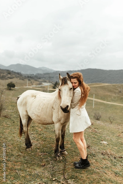 Fototapeta Beautiful girl with a horse. Nature and travel in the capital of Georgia.