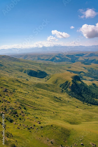 Fototapeta View from the Bermamyt Plateau on a summer day. Hills and clouds in the distance.